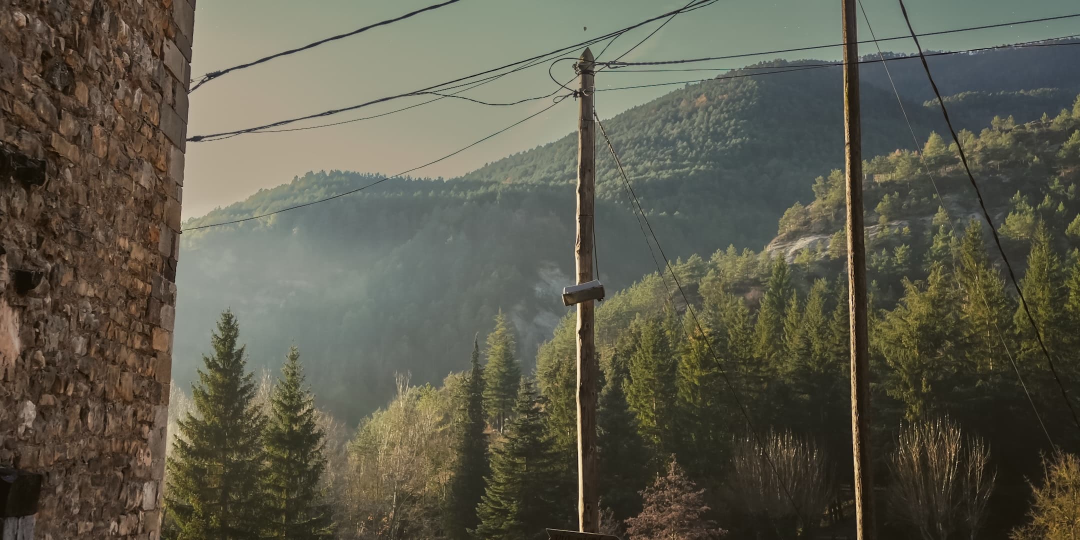 Mountain village road in winter haze photographed by Eugene Truuts