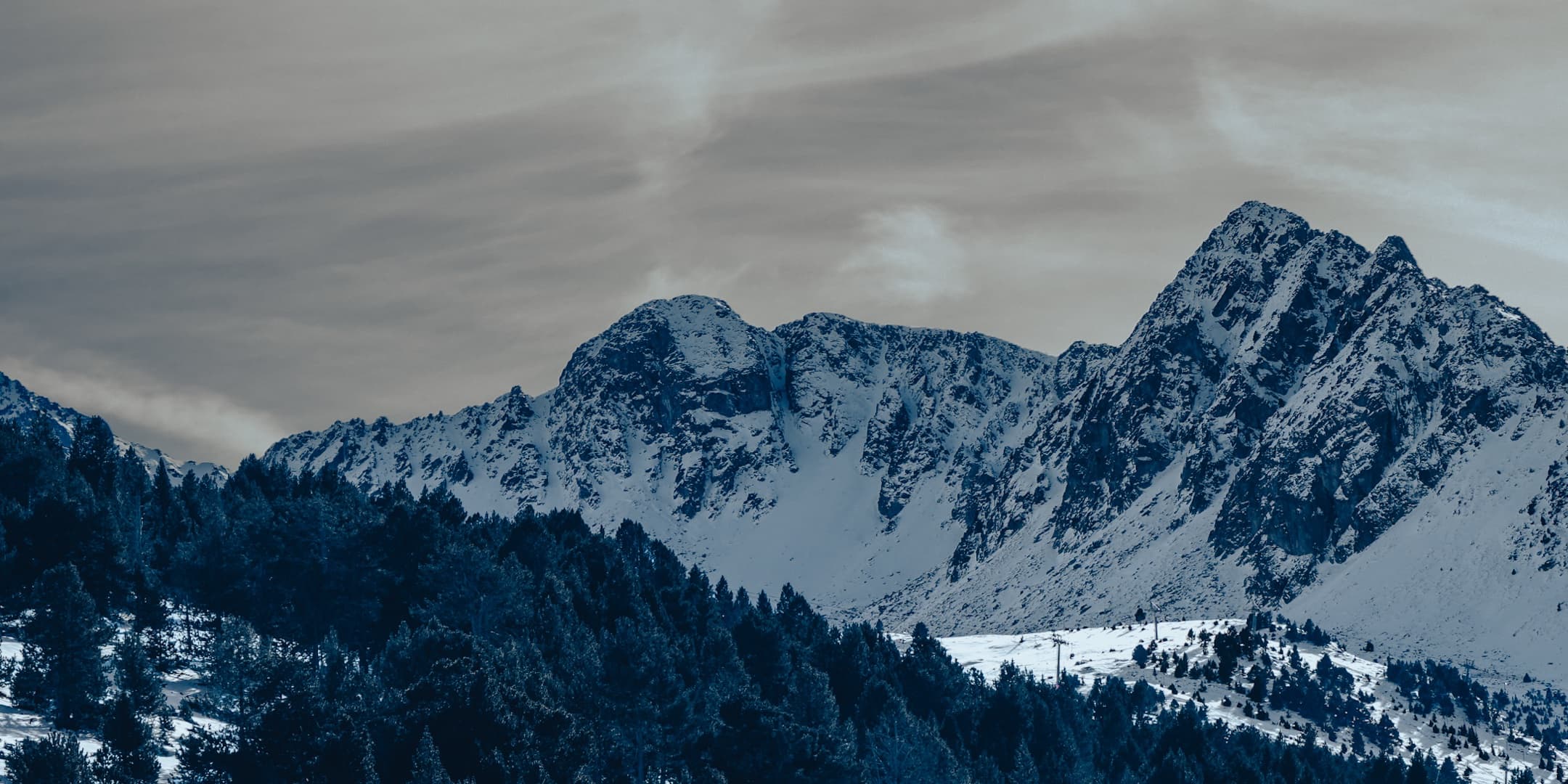 Jagged snow-covered mountain peaks photographed by Eugene Truuts
