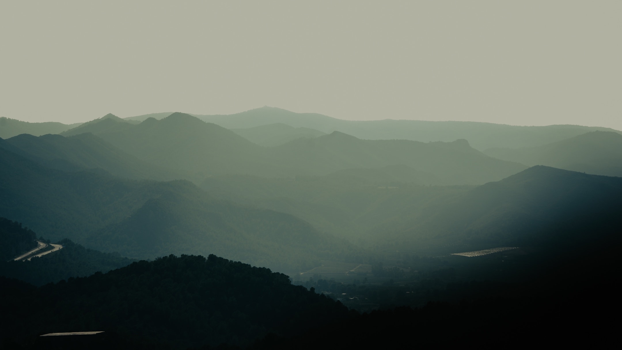 Layered mountain ridges at sunset photographed by Eugene Truuts